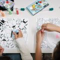 two girls coloring on sensory mat using peel and stick paints